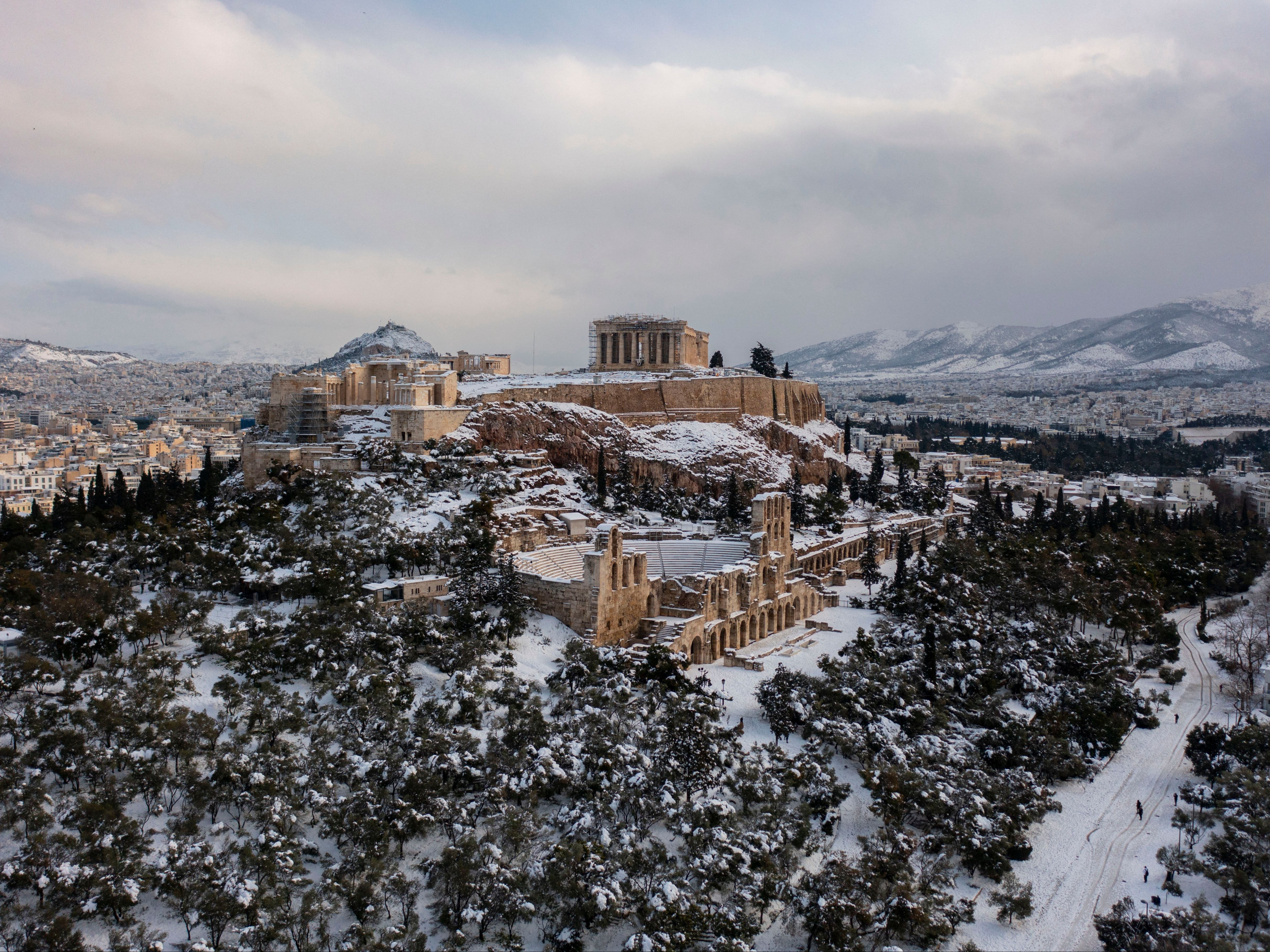 The snow covered Ancient Temple of Parthenon atop the Acropolis hill