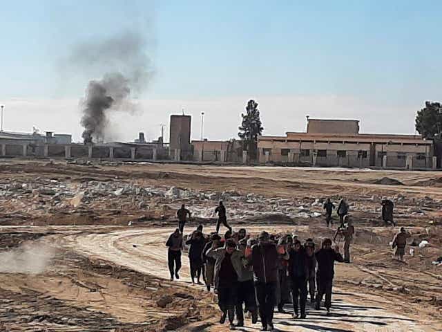 <p>Islamic State militants surrender after clashing with Kurdish-led Syrian Democratic Forces, at Gweiran Prison</p>