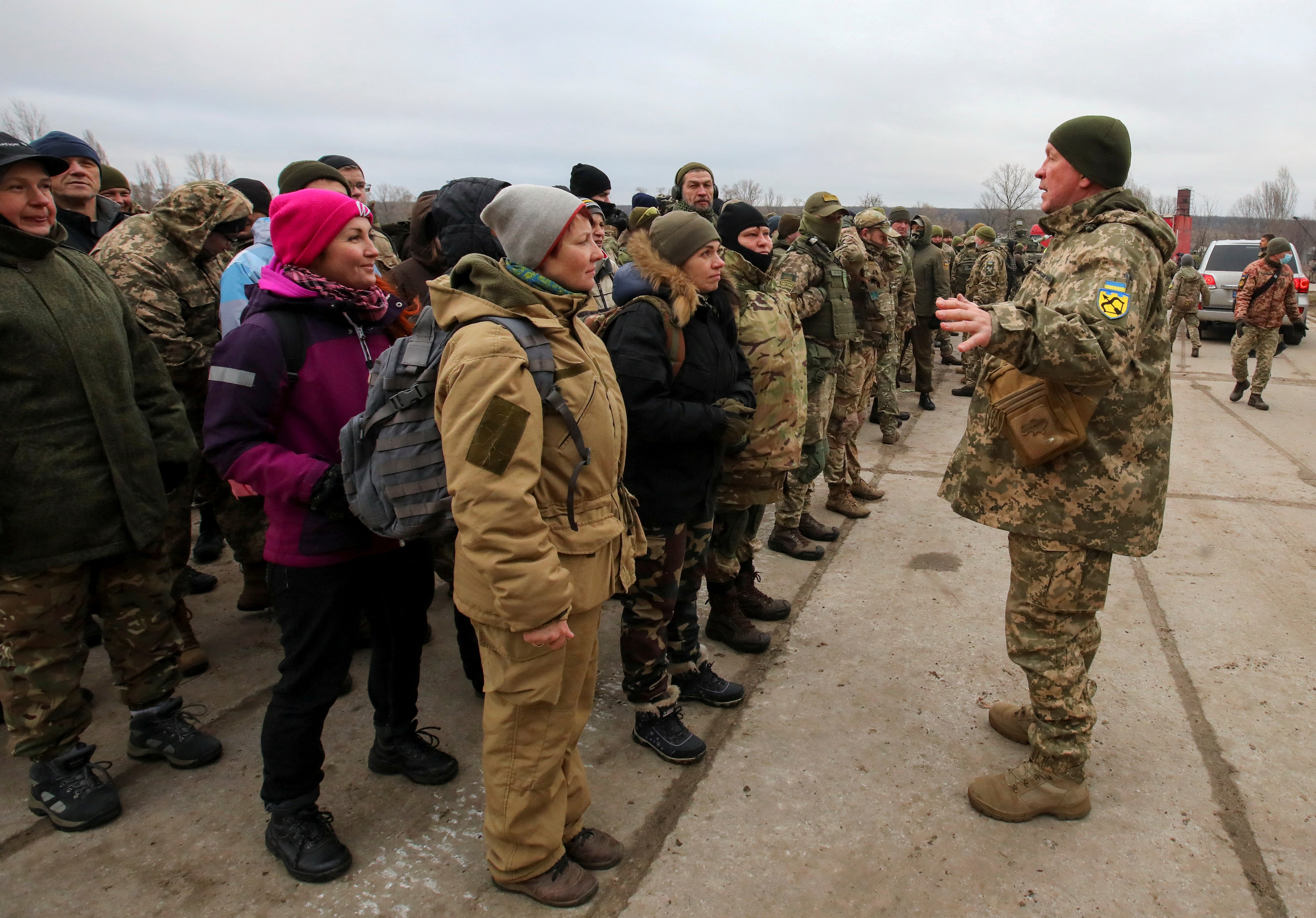Reservists of the Ukrainian Territorial Defence Forces listen to instructions during military exercises at a training ground outside Kharkiv