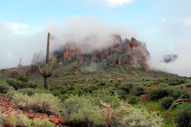 <p>File photo: Low-hanging winter clouds hug part of Superstition Mountain in Lost Dutchman State Park in Arizona, from where a hiker fell this week </p>