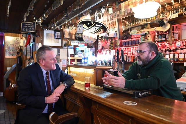 Finance Minister Conor Murphy (left) with Barney Vallalay in Maddens Bar, Belfast (Michael Cooper/PA)