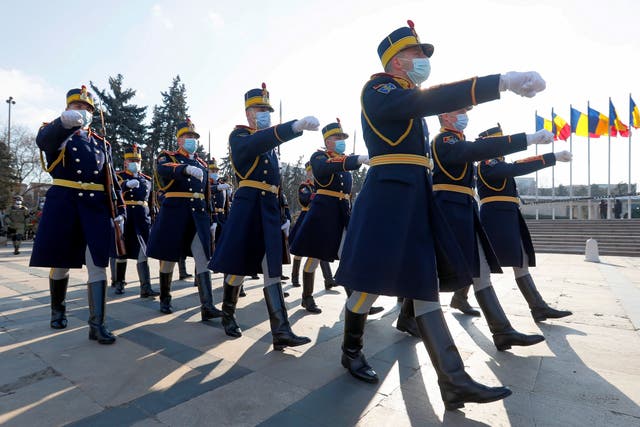 <p>Romanian presidential honour guard soldiers march during a military ceremony held to mark Romania’s Little Union Day at the Tomb of the Unknown Soldier Memorial in Bucharest</p>