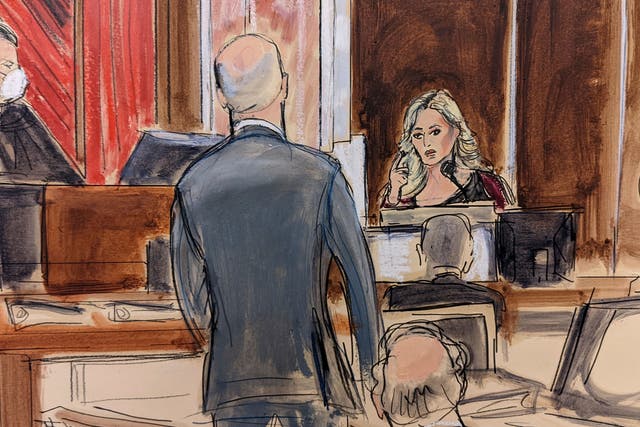 <p>Stormy Daniels testifying on the witness stand, at right, points to Michael Avenatti, standing at center. Judge Jesse Furman presides on the bench</p>