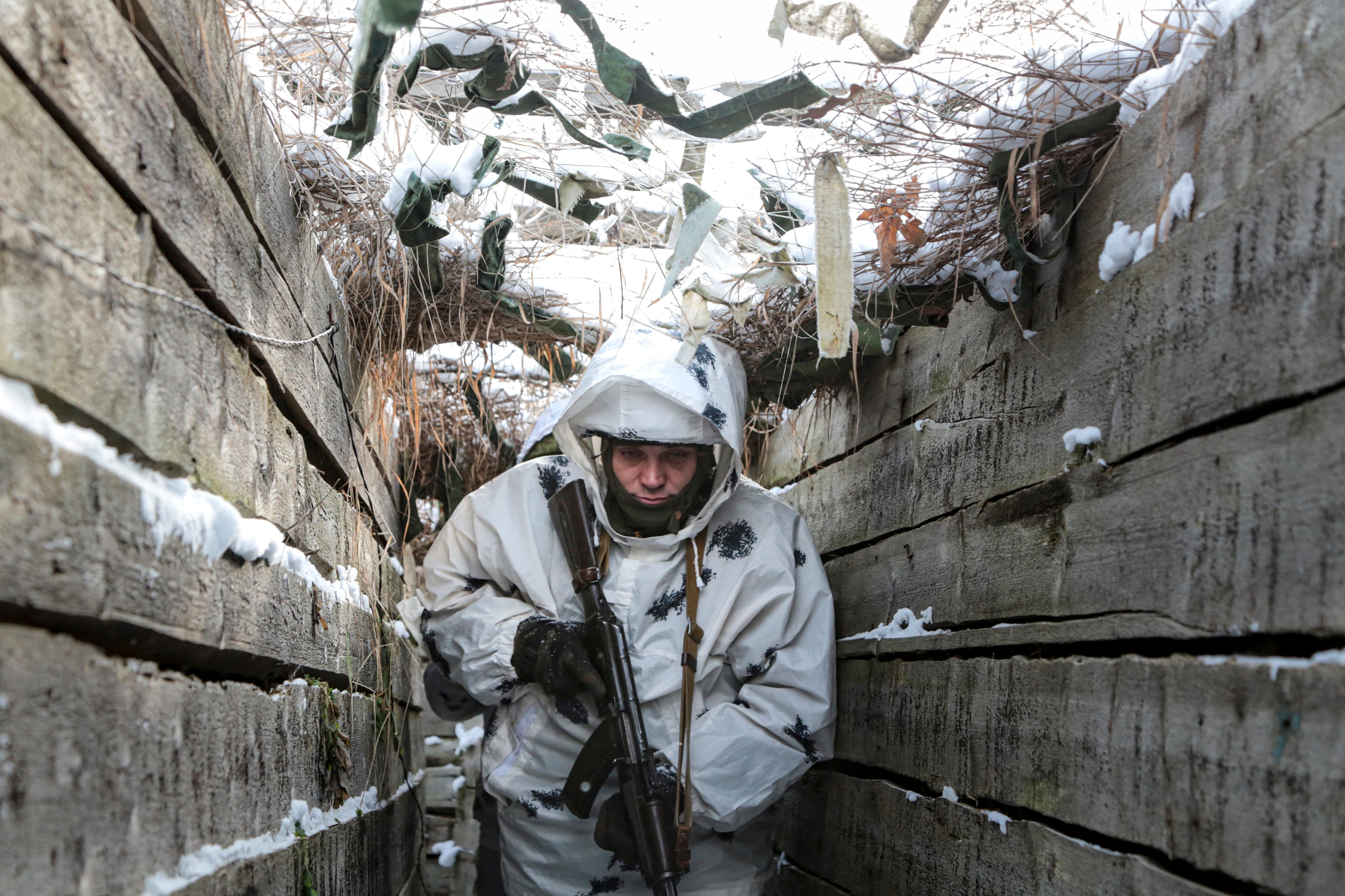 An armed serviceman walks along a trench on the territory controlled by pro-Russian militants on the frontline with Ukrainian government forces near Spartak village in Yasynuvata district of Donetsk region, eastern Ukraine