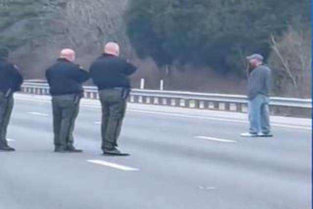 <p>In a video captured by a bystander, Landon Eastep can be seen standing on the right lane of the highway as a dozen uniformed officers draw their guns</p>