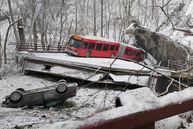 <p>A Port Authority bus and a car that were on the bridge when it collapsed early on Friday</p>