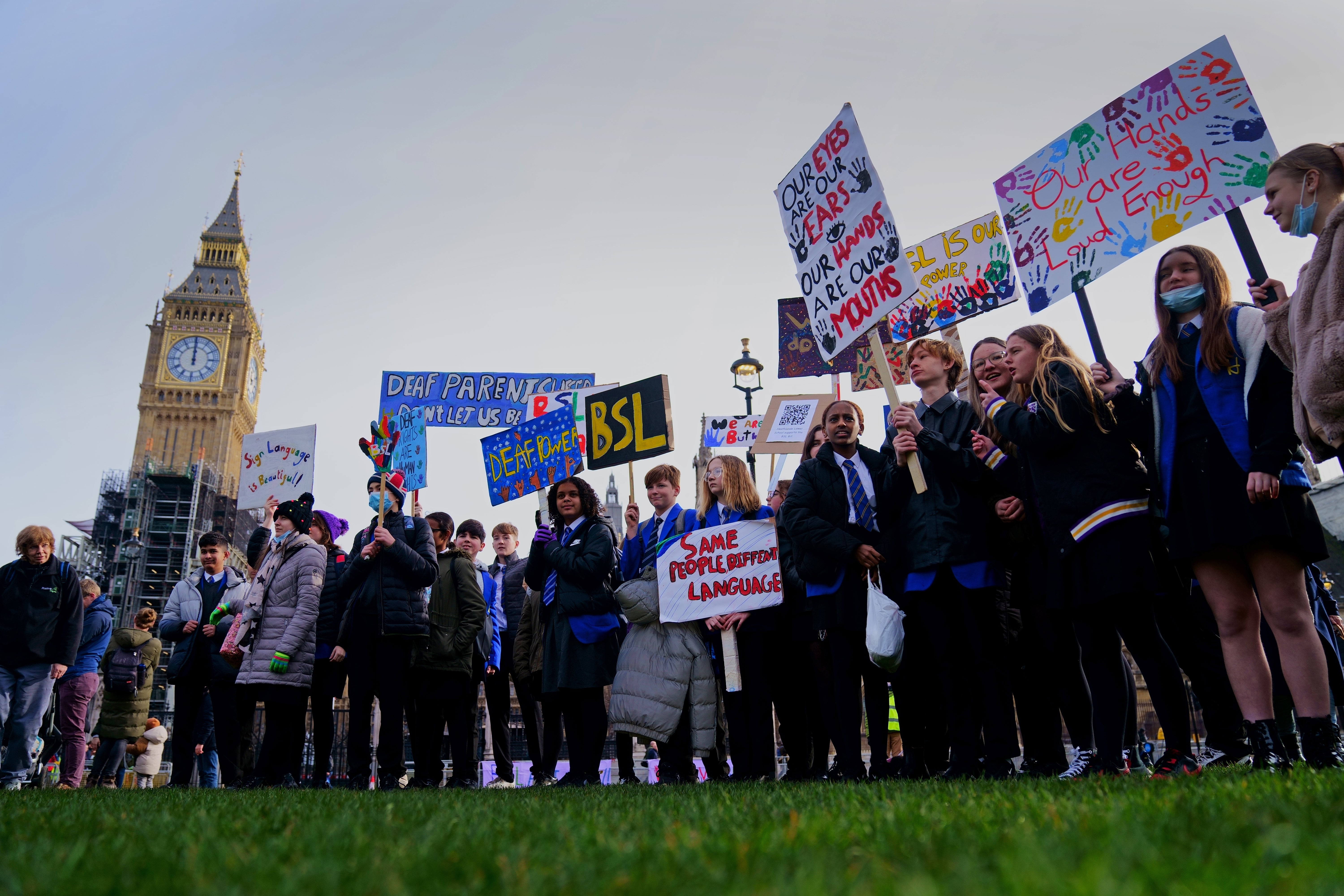 School children take part in a rally in support of British Sign Language becoming a recognised language in the UK (Victoria Jones/PA)