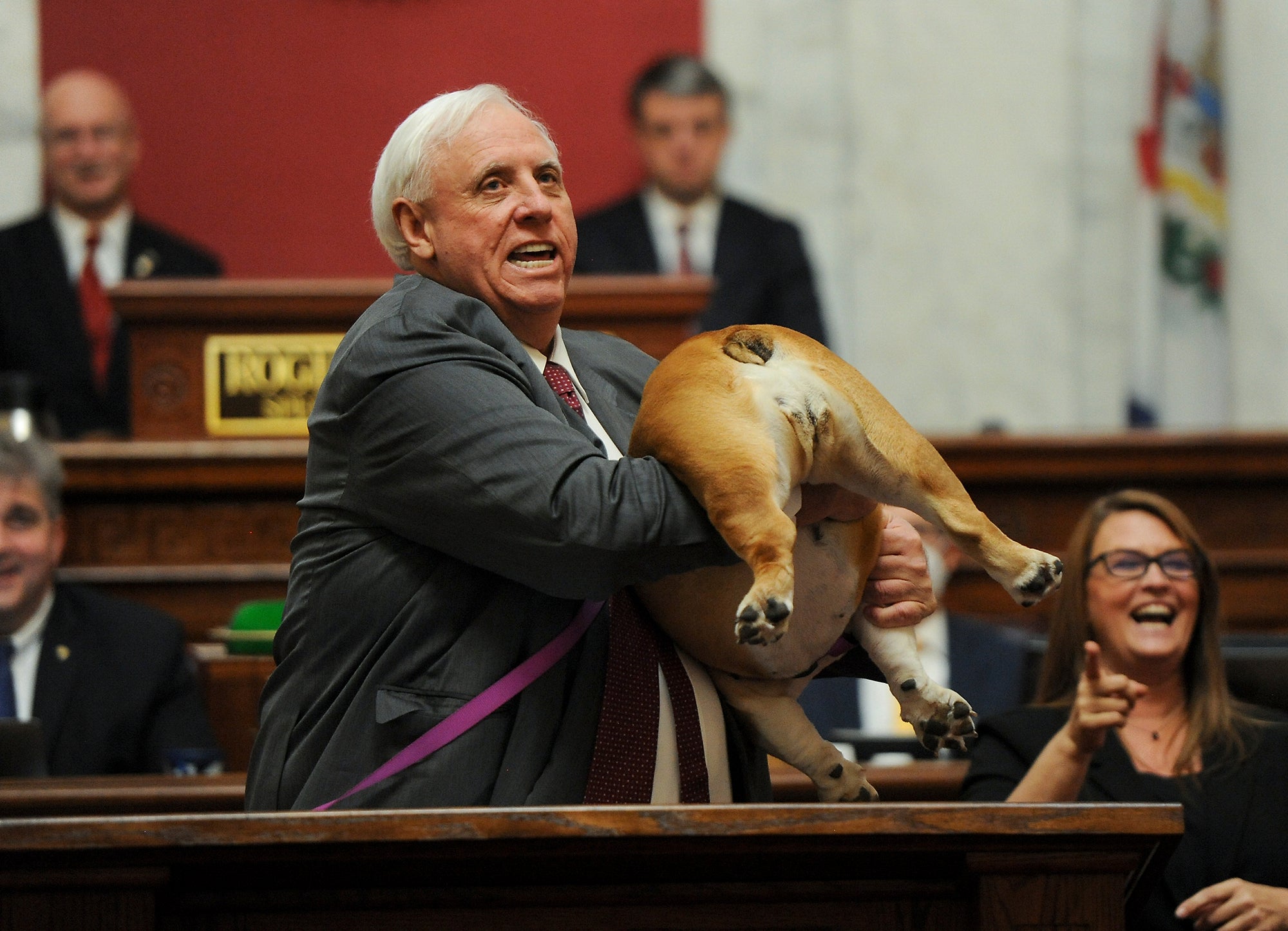 Governor Justice holds up Babydog’s rear end as a message to those who doubted the state