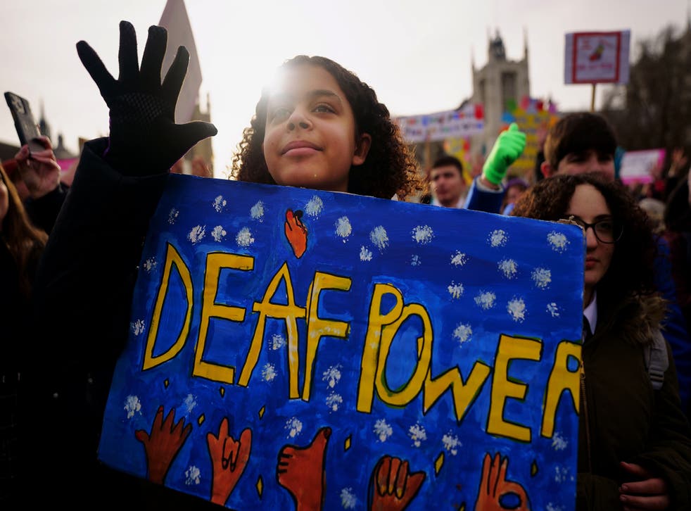 A young girl takes part in a rally in support of British Sign Language becoming a recognised language in the UK (Victoria Jones/PA)