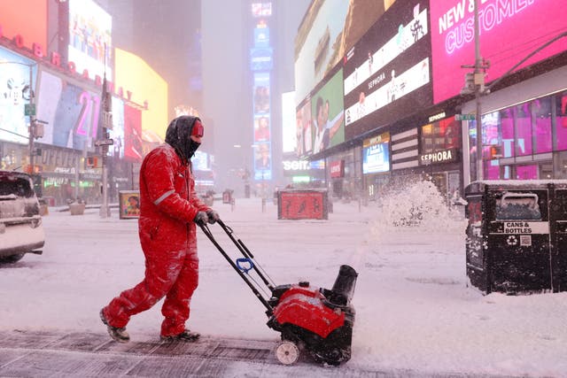 <p>A worker clears snow in Times Square during a Nor'easter storm in Manhattan, New York City, U.S., January 29, 2022</p>