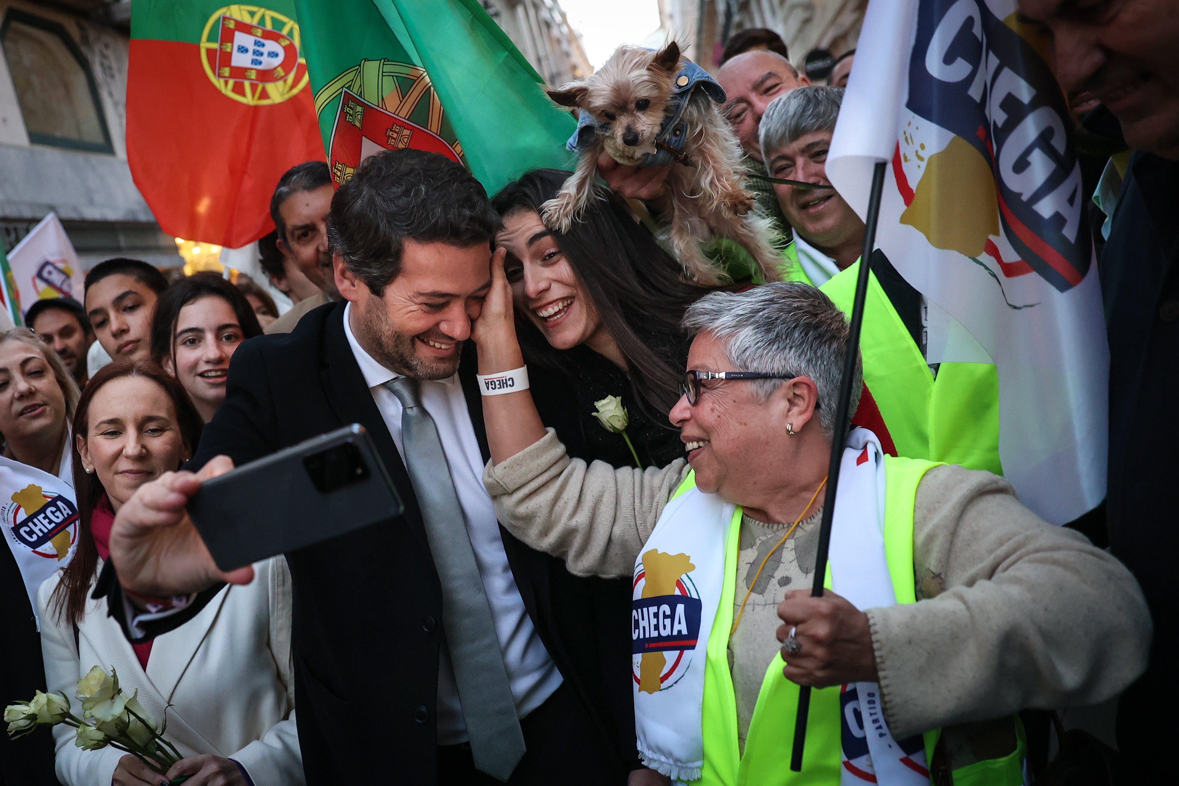 Far-right Party Chega leader Andre Ventura, centre, takes a selfie with the Portuguese actress, Maria Vieira, right, during the election campaign