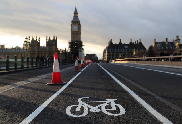 A newly painted bicycle sign is seen on the middle of the road at Westminster Bridge, as the new Highway Code rules start today together with giving pedestrians priority at junctions