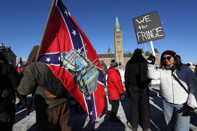 <p>A supporter carries a US Confederate flag during the ‘Freedom Convoy’ protest in Ottowa </p>