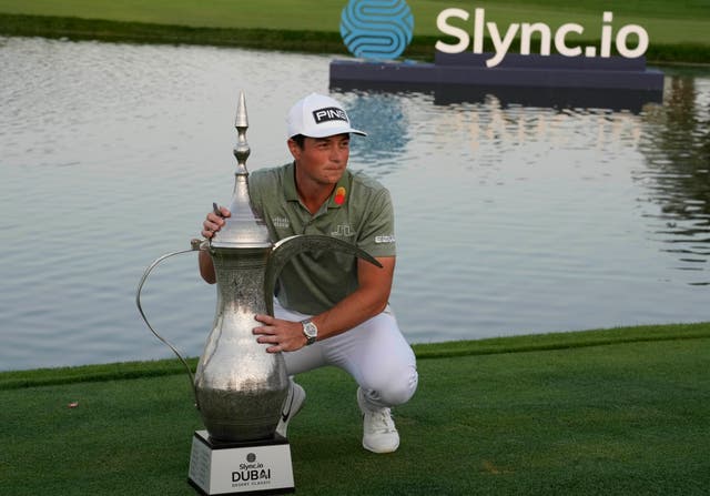 <p>Viktor Hovland celebrated with the trophy (Kamran Jebreili/AP)</p>