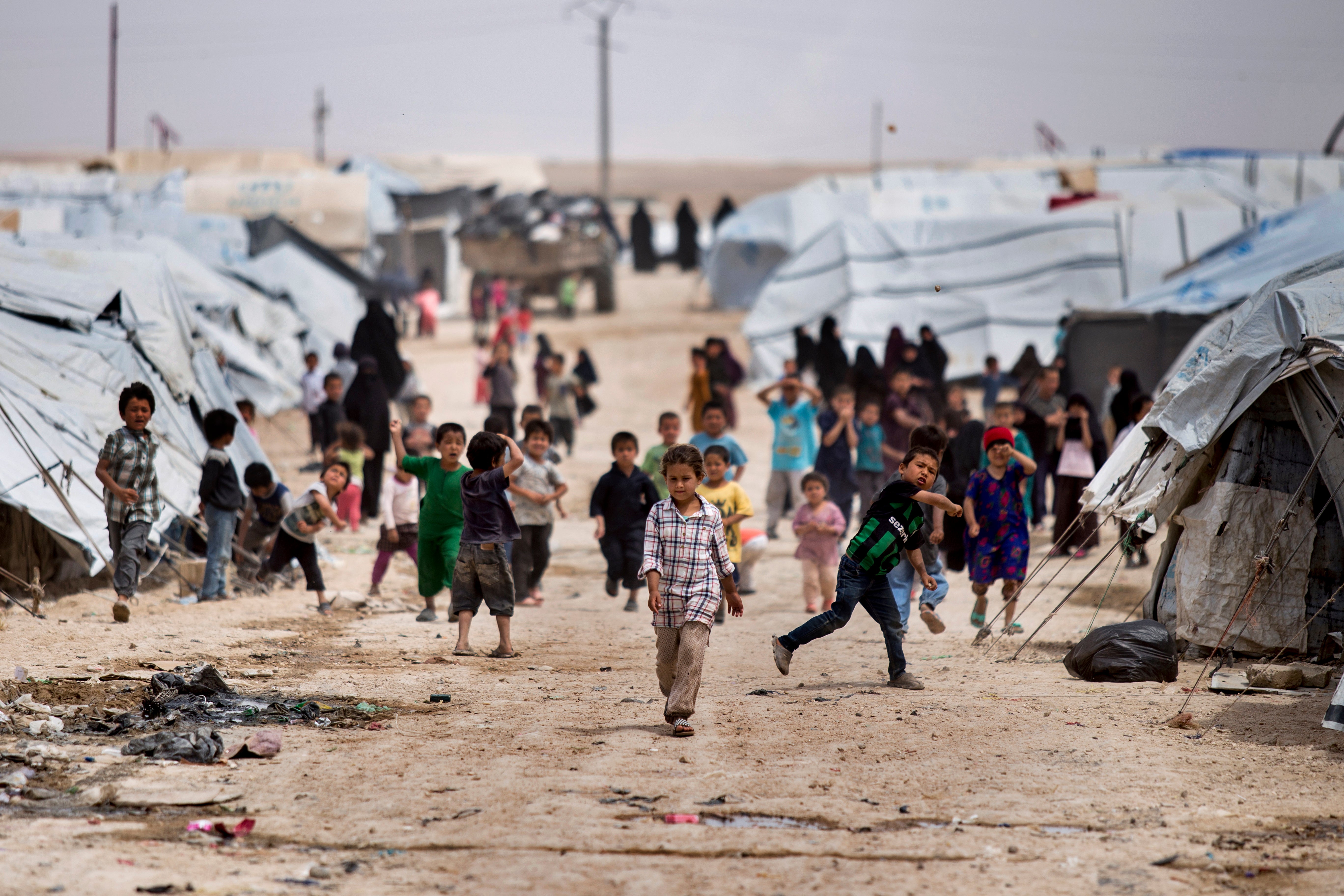 Children gather outside their tents, at al-Hol camp, which houses families of members of the Islamic State group, in Hasakeh