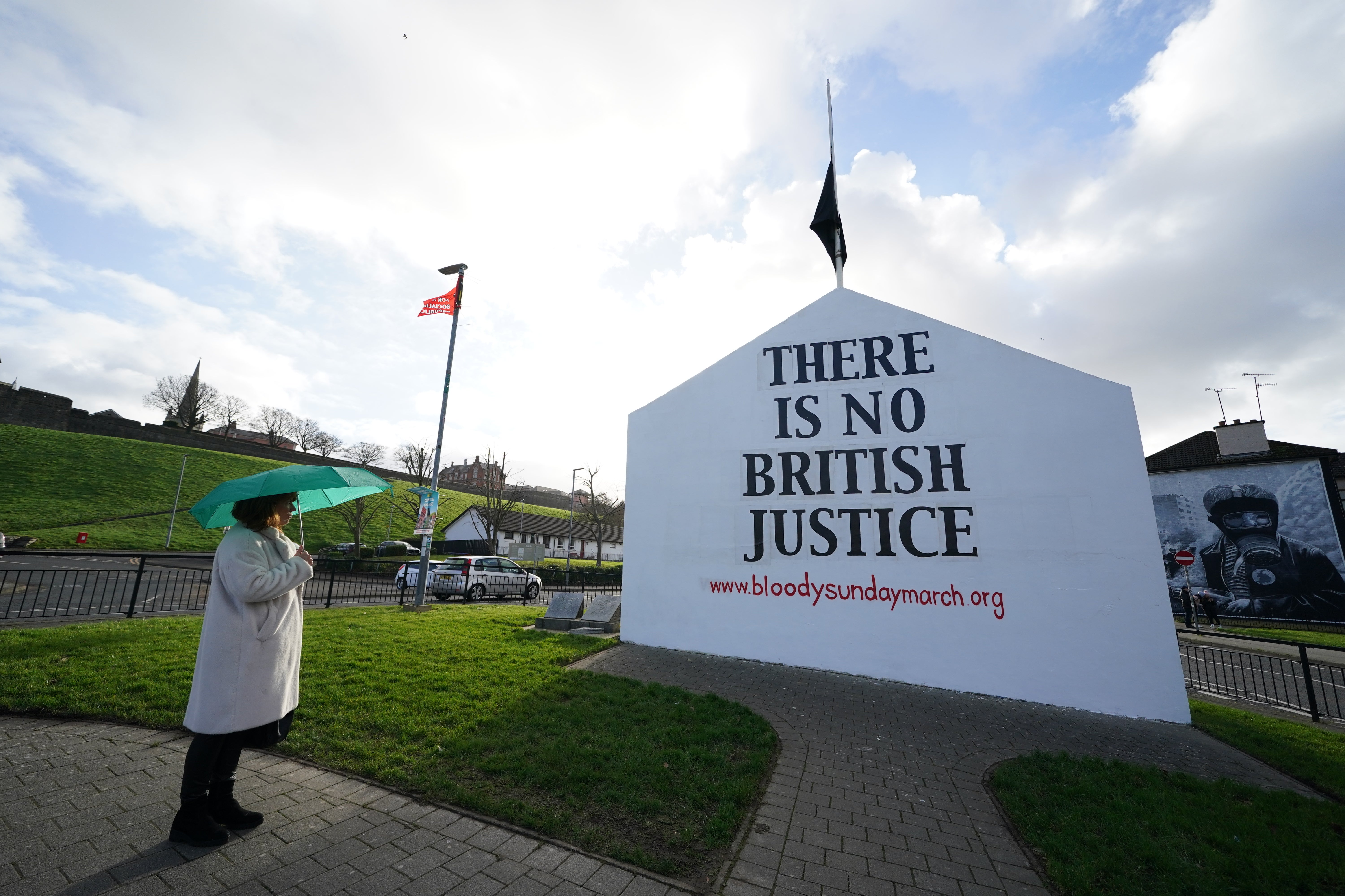A woman looks at Free Derry Corner ahead of the 50th anniversary of Bloody Sunday (Brian Lawless/PA)