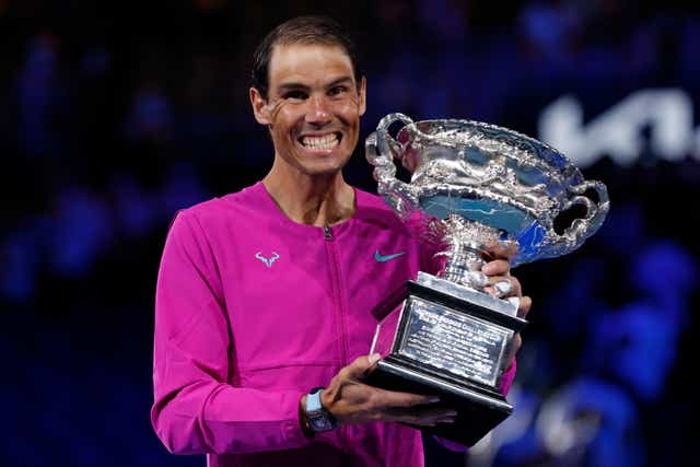 Rafael Nadal shows his delight as he holds the Norman Brookes Challenge Cup (Hamish Blair/AP)