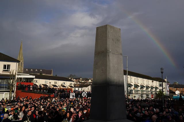 A rainbow is seen above the Bloody Sunday Memorial in Derry as people gather to mark the 50th anniversary of Bloody Sunday (PA)