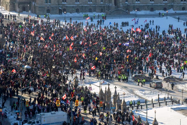 <p>Supporters arrive at Parliament Hill for the Freedom Truck Convoy to protest against Covid-19 vaccine mandates and restrictions in Ottawa, Canada, on January 29, 2022. </p>