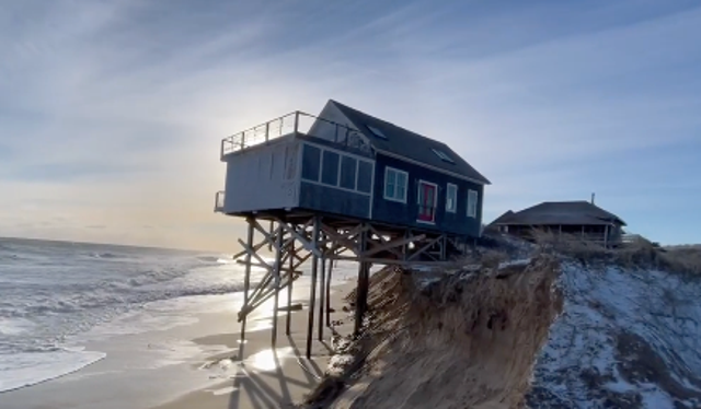 <p>A house in Truro, Massachusetts, teeters over the ocean after powerful storms blanketed the northeast US beginning on Friday, 28 January, 2021.</p>