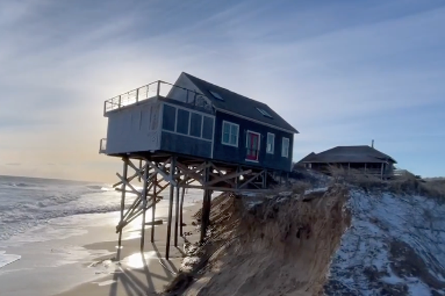 <p>A house in Truro, Massachusetts, teeters over the ocean after powerful storms blanketed the northeast US beginning on Friday, 28 January, 2021.</p>