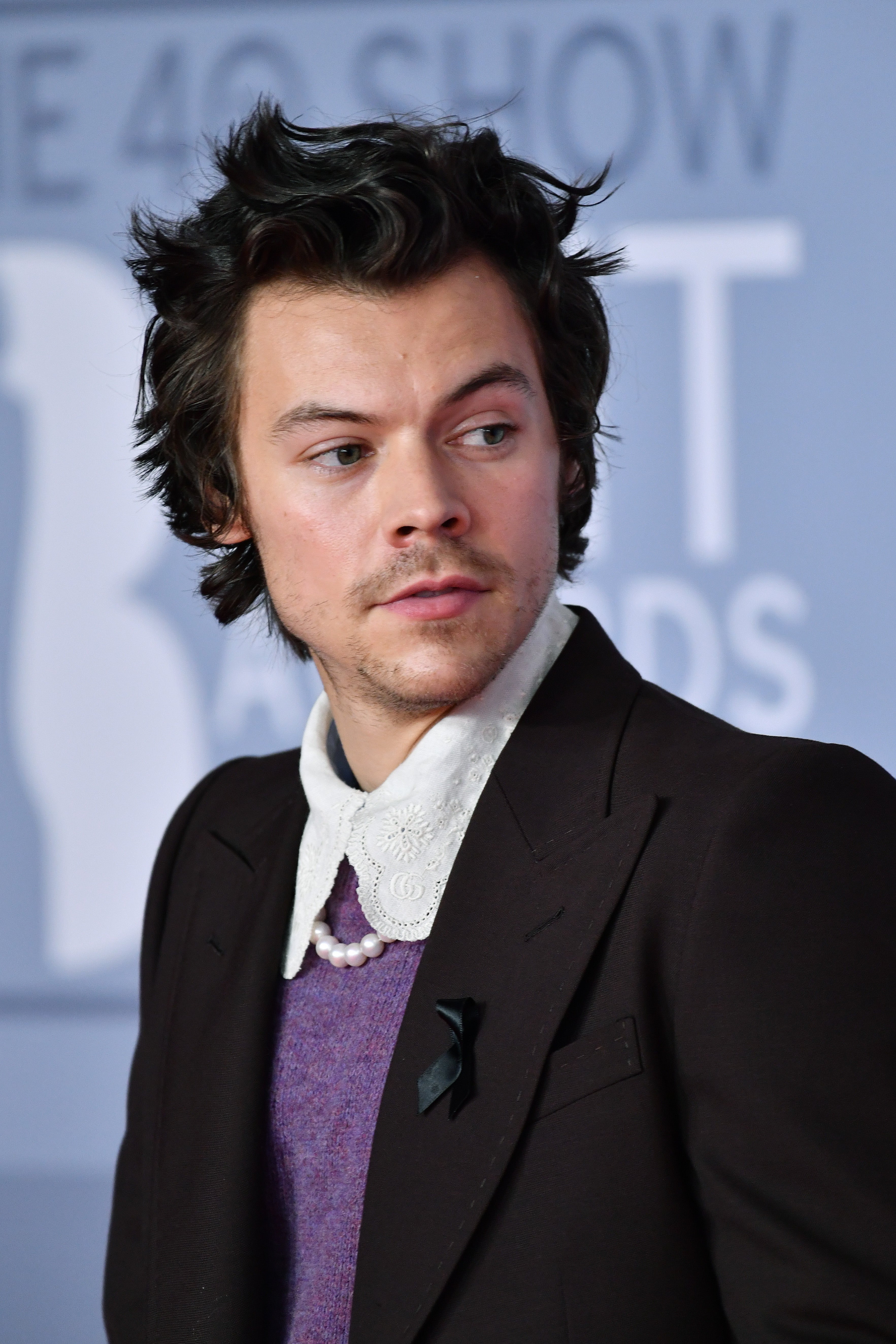 Styles wore a small black ribbon at the Brit Awards in 2020, as a symbol of mourning for Caroline Flack