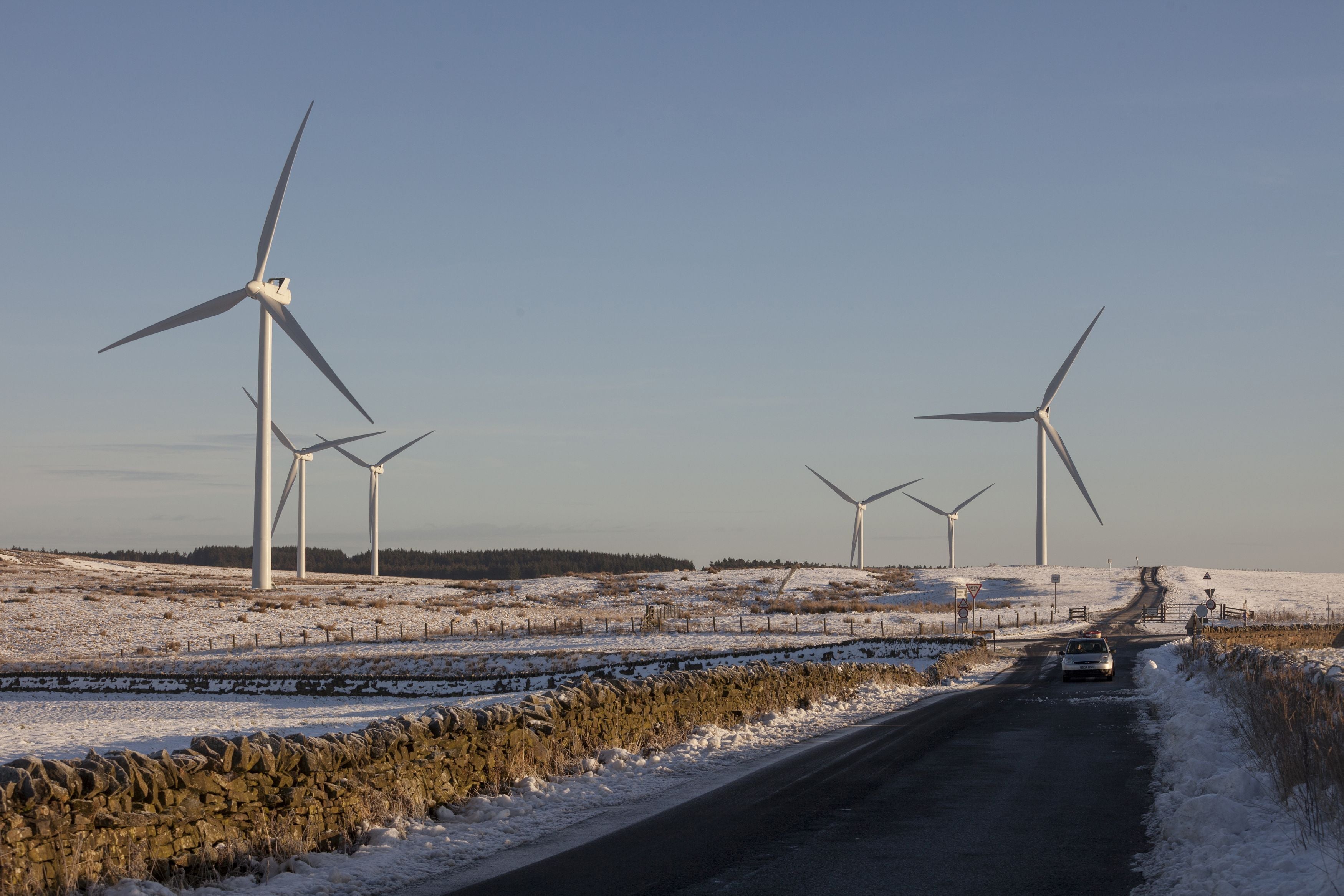 Wind turbines stand in a snowy scene in Northumberland (Tom White/PA)