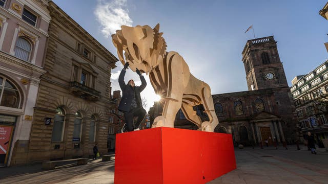 Nelson Beaumont-Laurencia applies finishing touches to a sculpture of a tiger,  commissioned by Manchester Business Improvement District to celebrate the Chinese New Year, is unveiled in St Ann’s Square