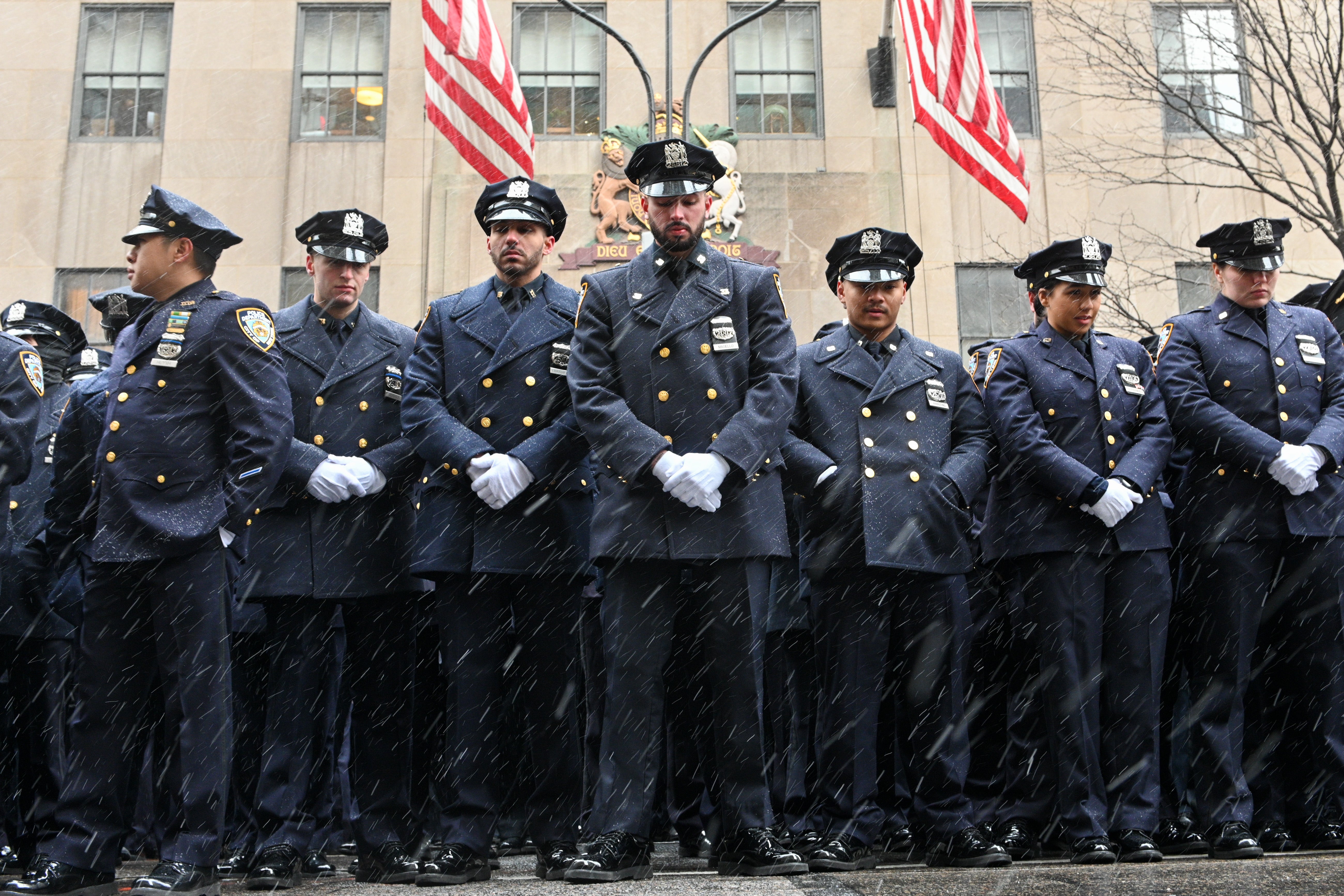 New York City Police Department officers mourn two officers fatally shot in January.