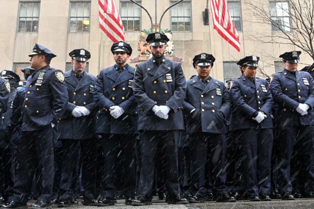 <p>New York City Police Department officers mourn two officers fatally shot in January. </p>