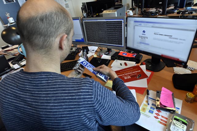 <p>An officer working in the offices of the Federal Computer Crime Unit (FCCU) in Brussels</p>