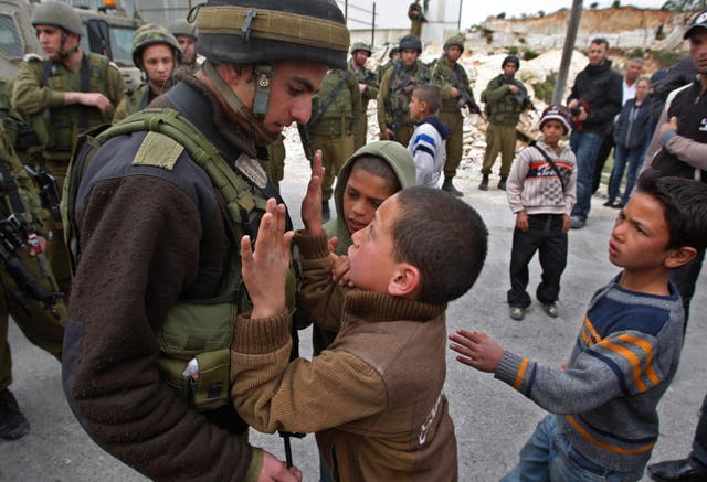 <p>A Palestinian youth is confronted by an Israeli soldier during a demonstration against Israel’s controversial separation barrier in the village of Maasarah, near the West Bank city of Bethlehem</p>