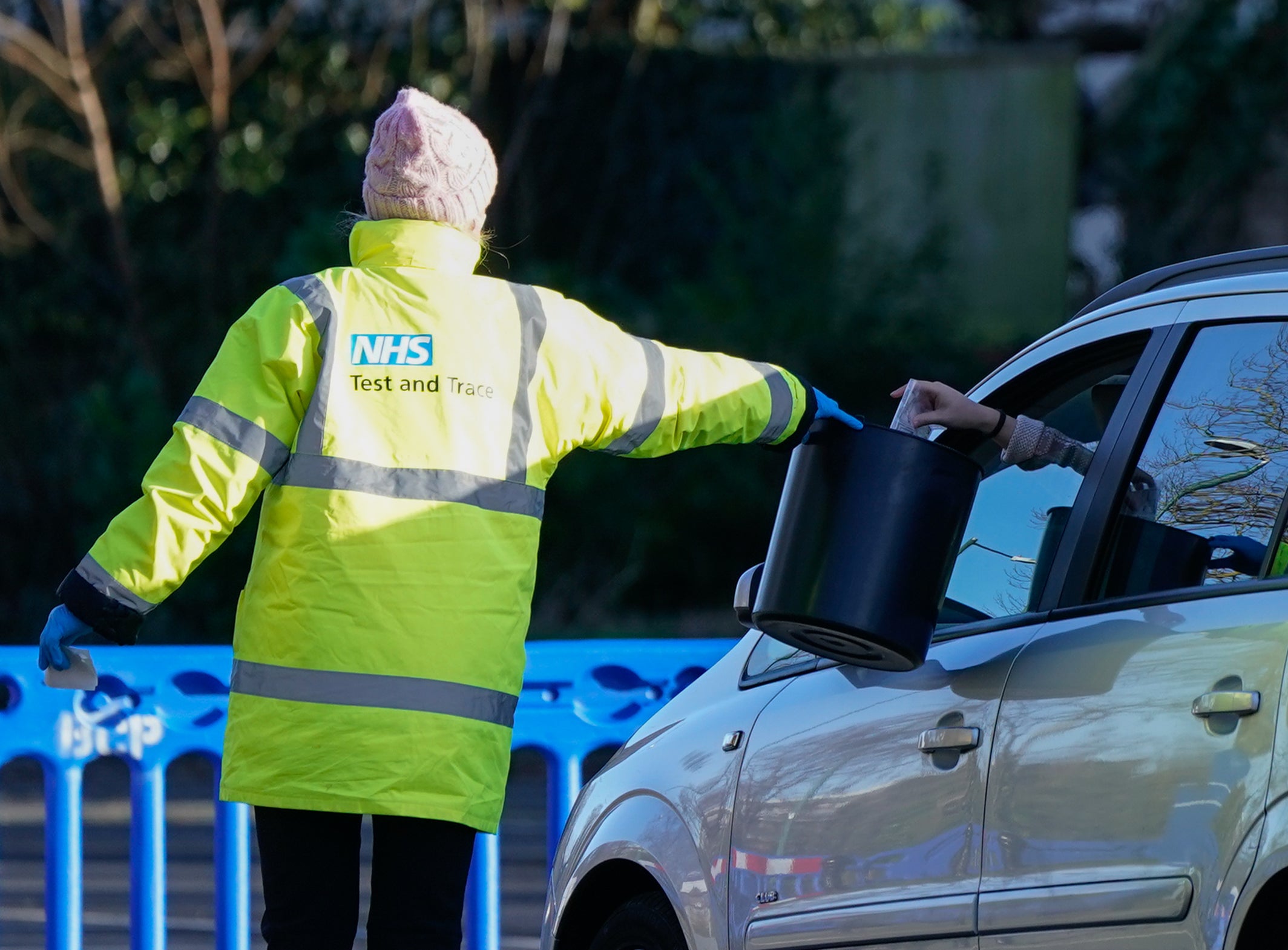 A member of NHS Test and Trace collects a sample from a member of the public at a Covid-19 testing site in Bournemouth (Andrew Matthews/PA)