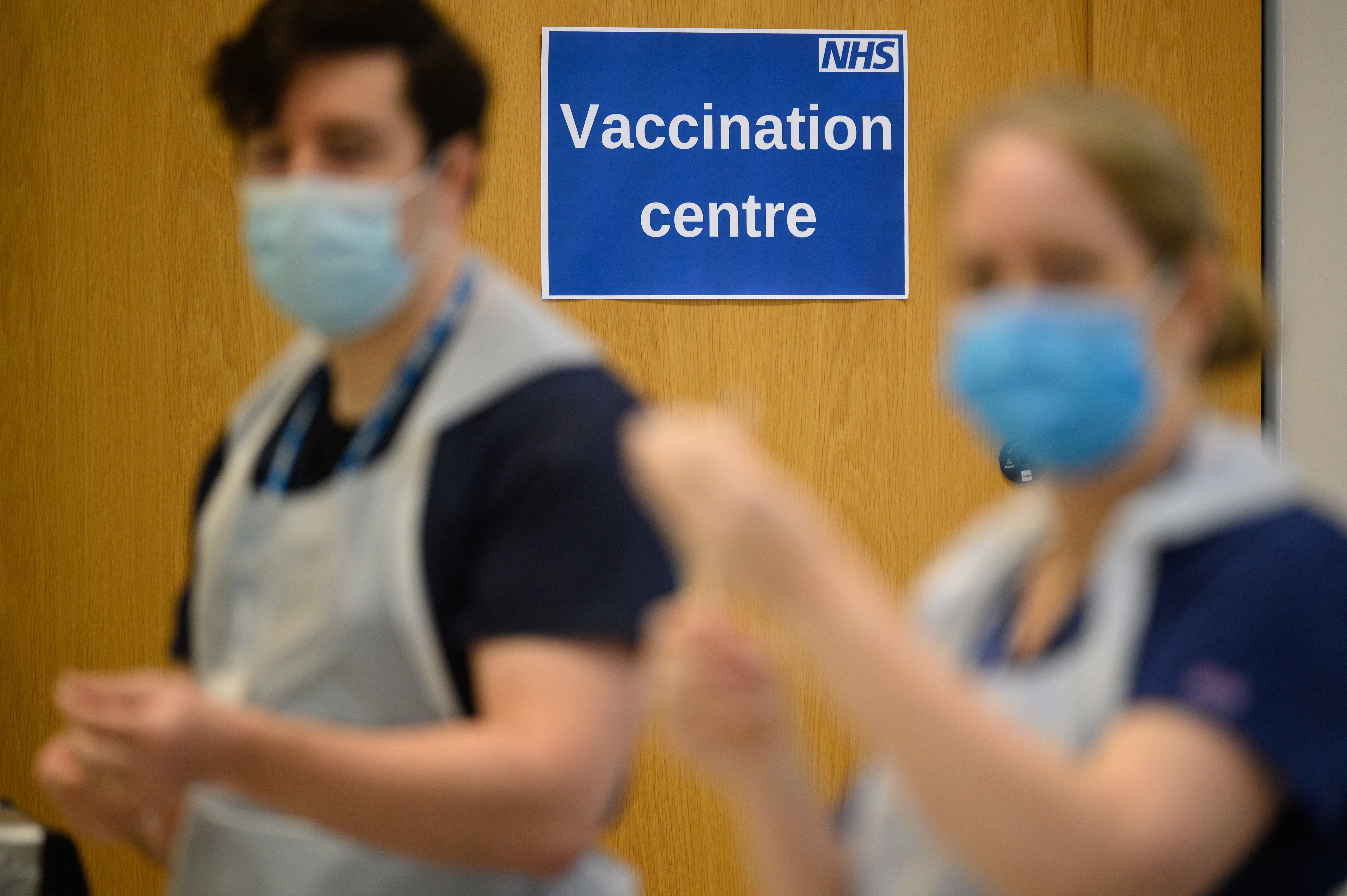 Medical staff and volunteers prepare vaccine shots (PA)