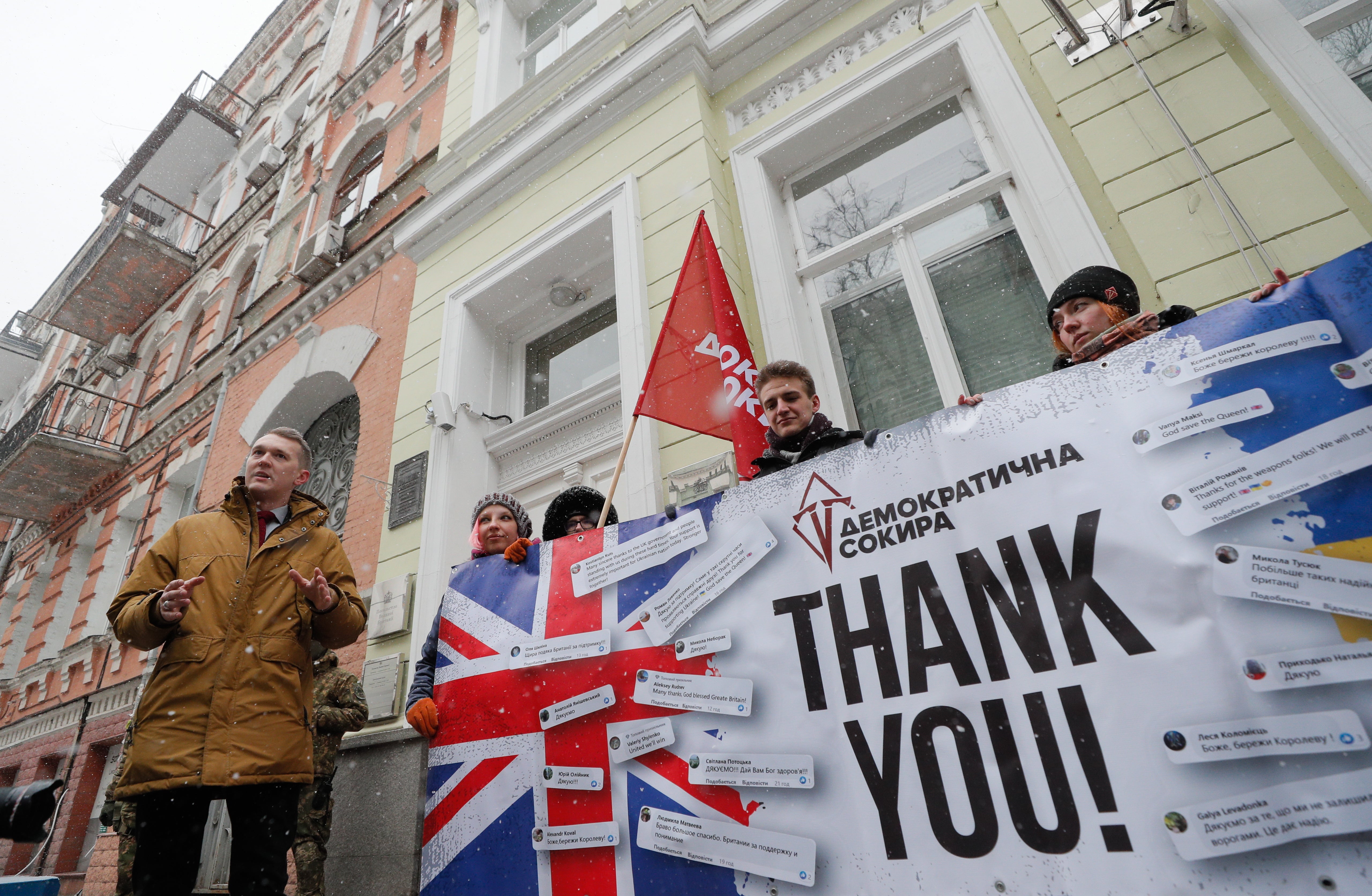 Members of the 'Demokratychna Sokyra' (Democratic Axe) pose with a banner near the UK embassy in Kiev