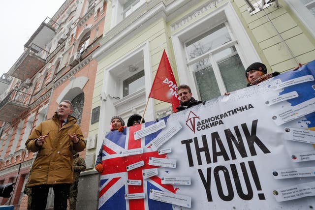 <p>Members of the 'Demokratychna Sokyra' (Democratic Axe) pose with a banner near the UK embassy in Kiev</p>