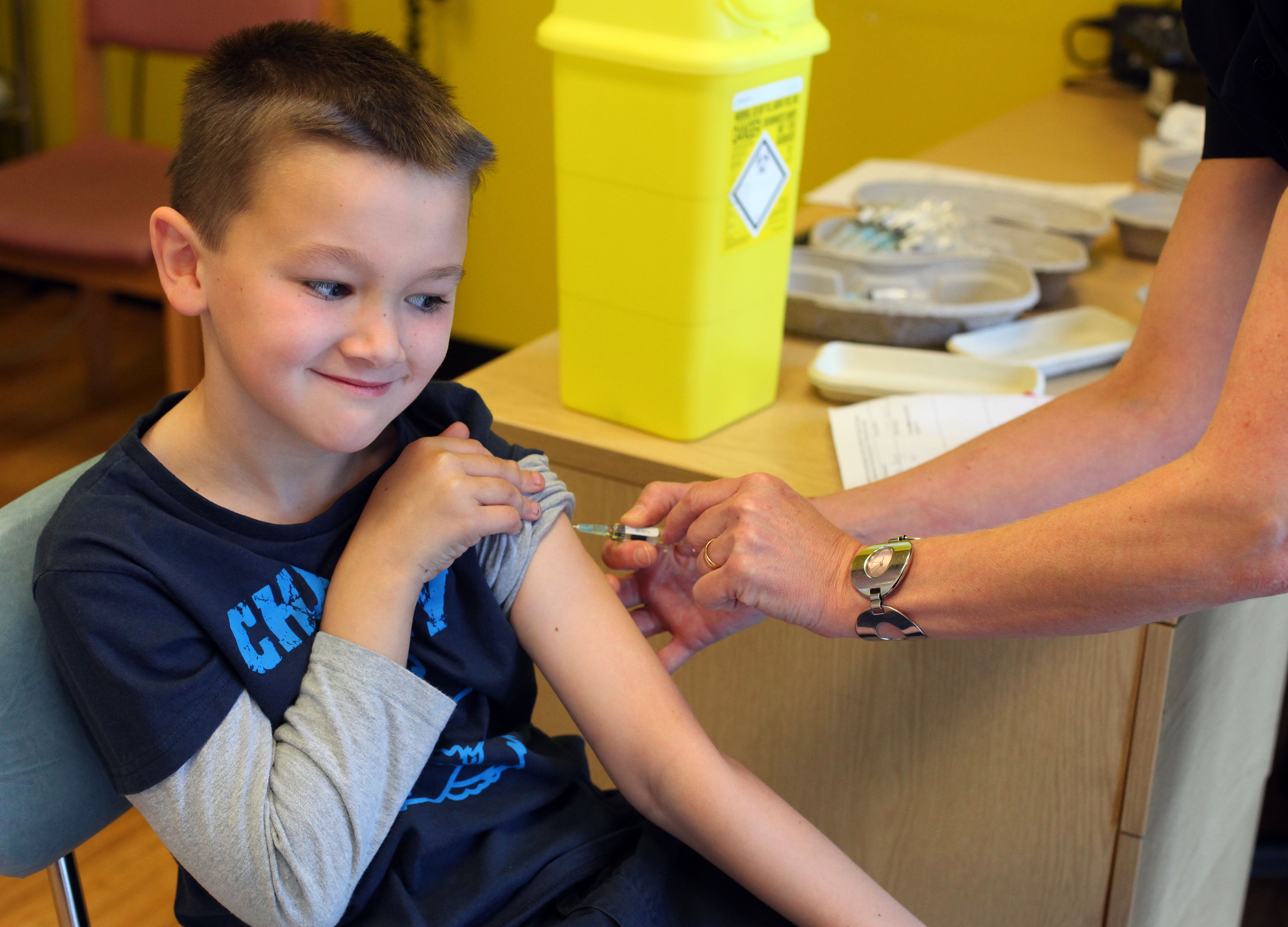 A boy receives the MMR jab at an drop-in clinic in Swansea