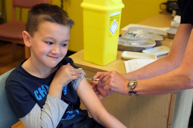 <p>A boy receives the MMR jab at an drop-in clinic in Swansea </p>