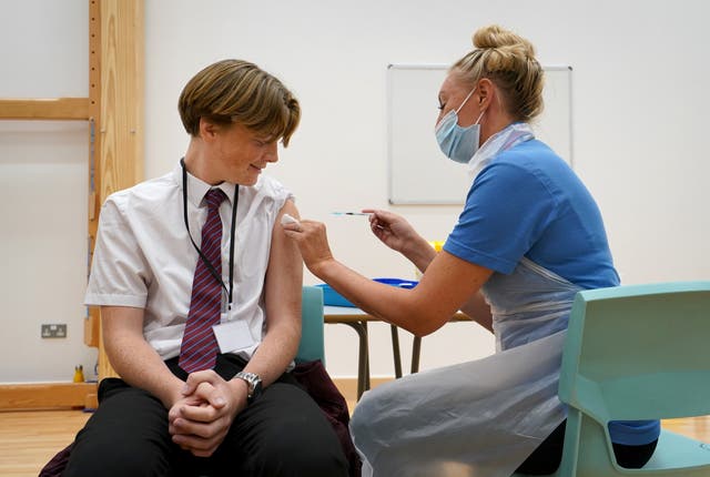 Fifteen-year-old Quinn Foakes receives a Covid-19 vaccination in Leigh-on-Sea in Essex (Gareth Fuller/PA)