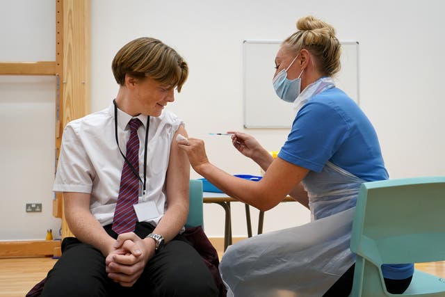 Fifteen-year-old Quinn Foakes receives a Covid-19 vaccination in Leigh-on-Sea in Essex (Gareth Fuller/PA)