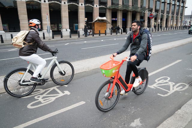 Schemes encouraging people to switch from cars to walking and cycling in London face a funding cut of nearly half a billion pounds (Stefan Rousseau/PA)