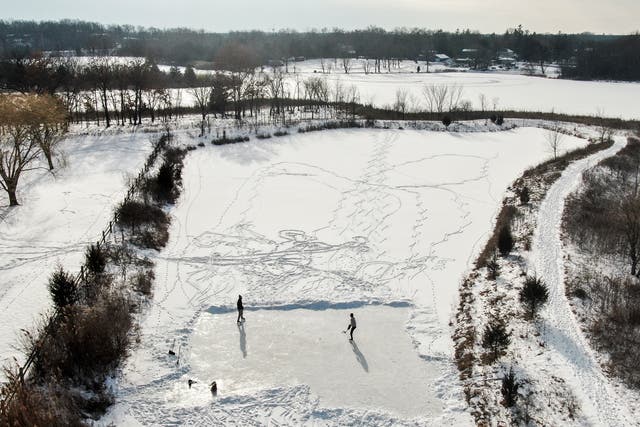 <p>Two men practicing their hockey skills on a frozen pond in Round Lake Heights, Illinois on Sunday. More snow and ice is on the way for the Midwest</p>