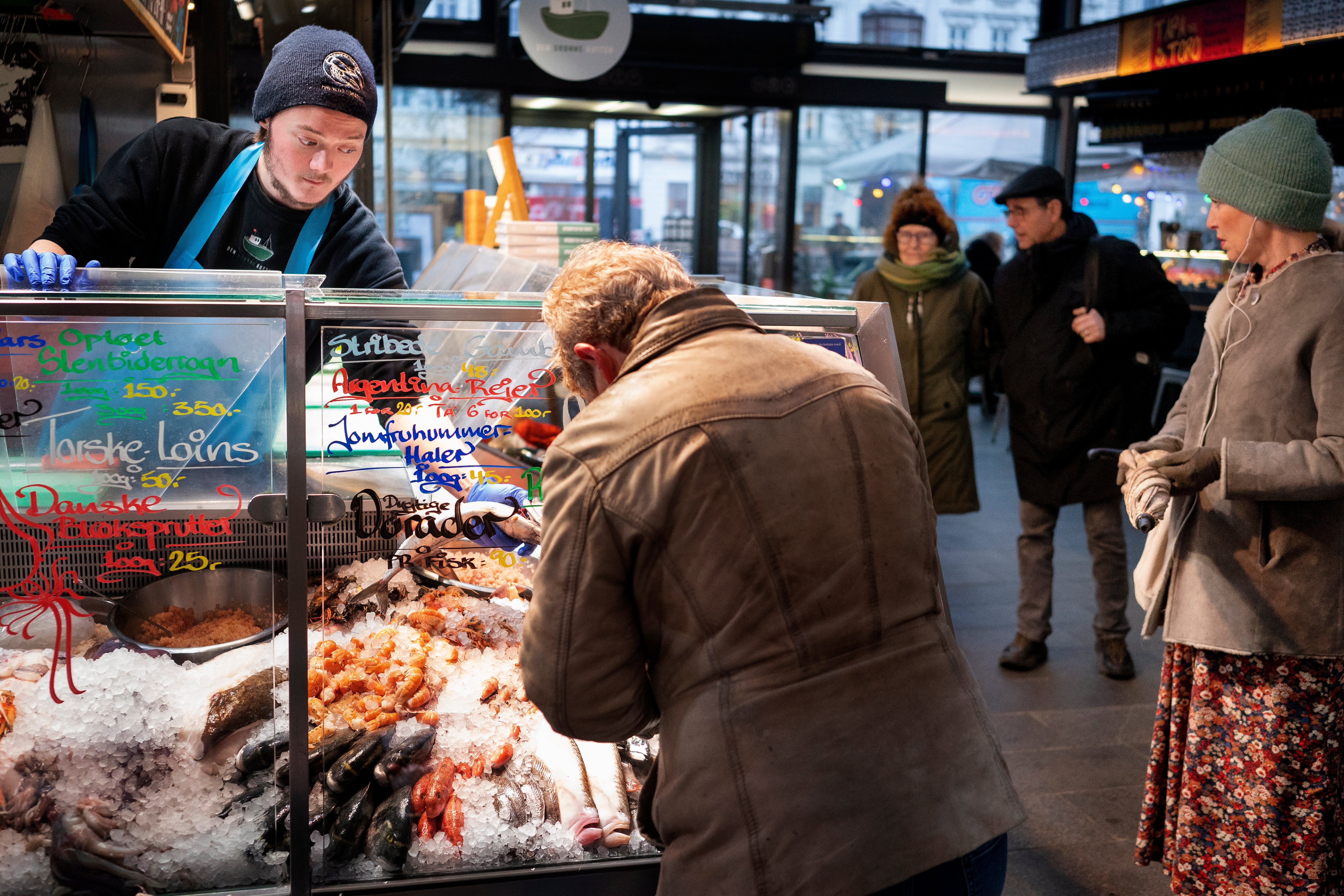 Customers at the fishmarket in Torvehallerne in Copenhagen. As of today it is no longer mandatory to wear protection mask anywhere in public in Denmark