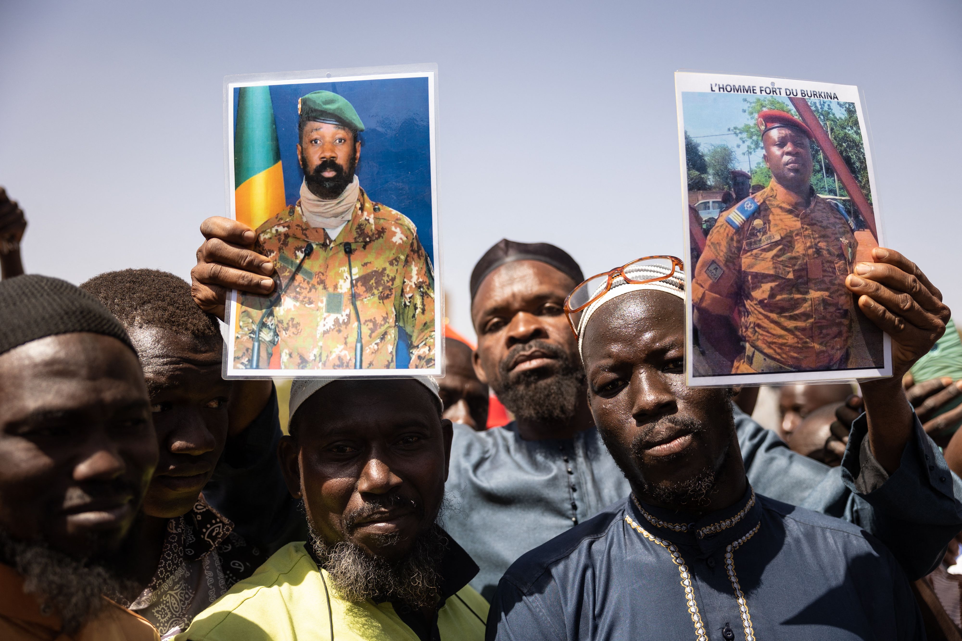 Demonstrators gathering in Ouagadougou, Burkino Faso, to show support for the military hold a picture of Colonel Aissimi Goïta