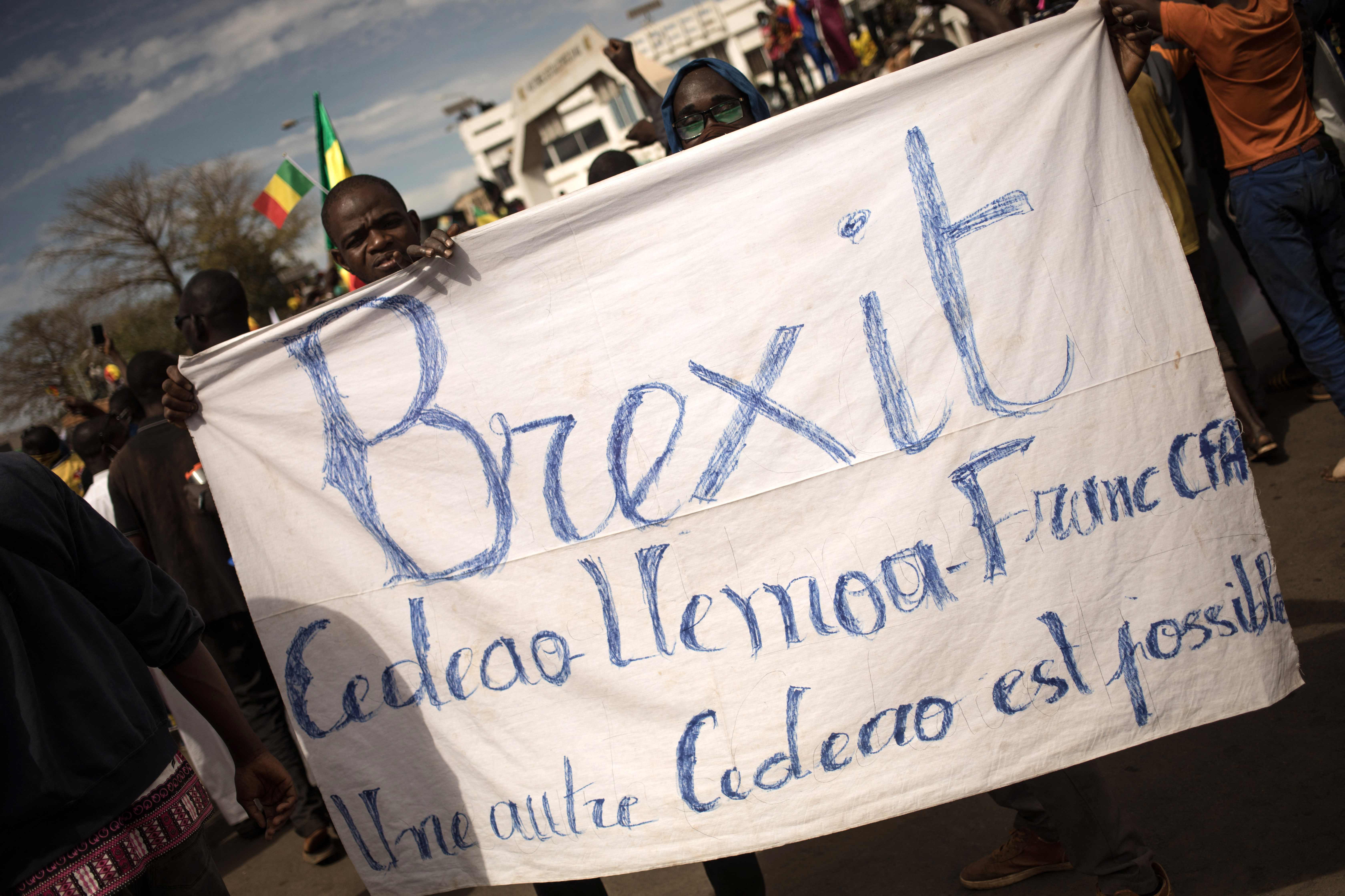 Young demonstrators hold a banner calling for a ‘Brexit’ from the Economic Community of West African States during a mass demonstration to protest against sanctions imposed on Mali
