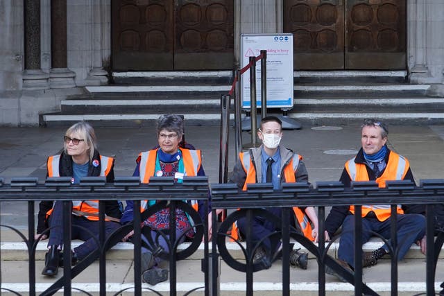 (Left to right) Insulate Britain defendants Theresa Norton, 63, Dr Diana Warner, 62, El Litten, 35 and Steve Pritchard, 62, sitting outside the Royal Courts of Justice in London, as they decided not to return to the afternoon session of their committal hearing (Ian West/PA)