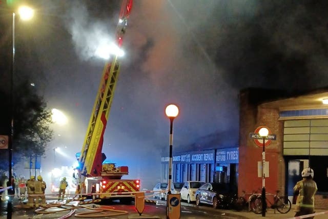 <p>Firefighters tackling a blaze at a car garage on Bollo Lane, Acton</p>