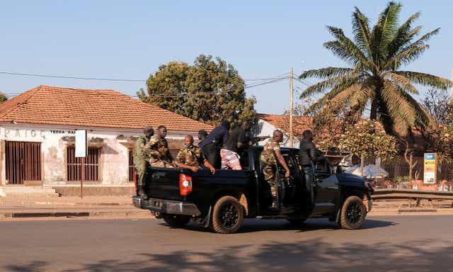 <p>Armed soldiers move on the main artery of the capital after heavy gunfire around the presidential palace in Bissau, Guinea Bissau, 1 February 2022</p>