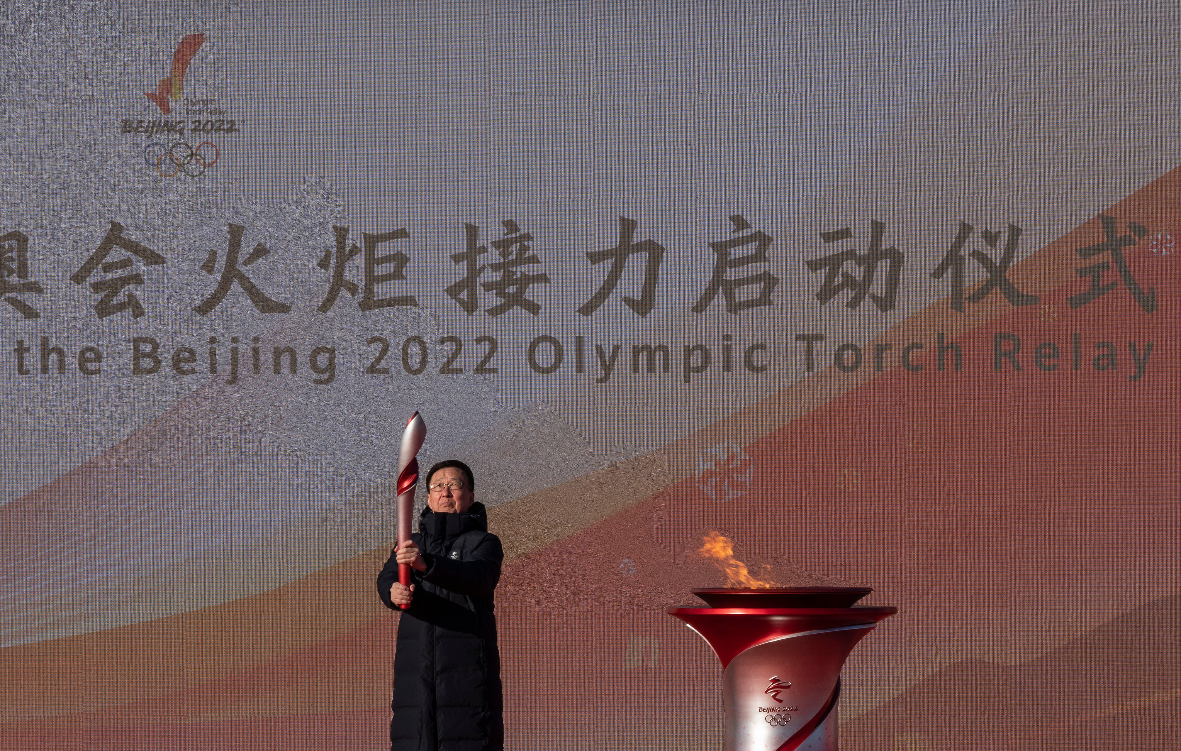 China’s vice premier Han Zheng holds the torch after lighting it during the launch ceremony for the Beijing 2022 Winter Olympics Torch Relay in front of the Olympic Tower outside of the closed loop bubble on 2 February