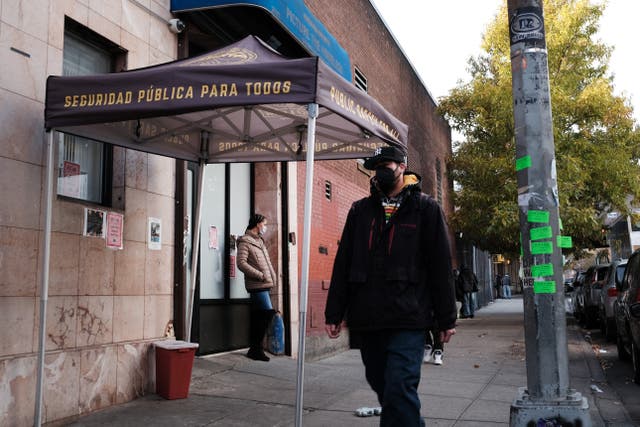 <p>People walk past an East Harlem health clinic that houses an overdose prevention room for drug users to consume under supervision</p>